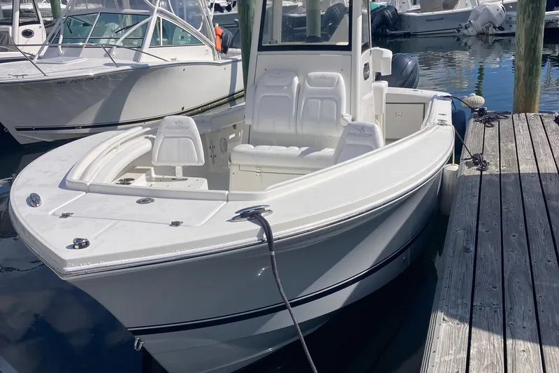 Slide: The Image of 2020 Regulator 23 Forward Seating boat docked at marina. - 7