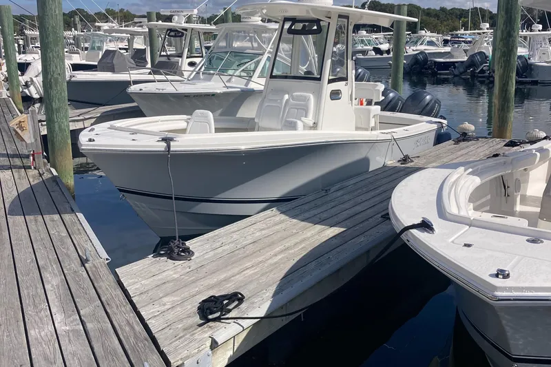 Slide: The Image of 2020 Regulator 23 Forward Seating boat docked at marina. - 9