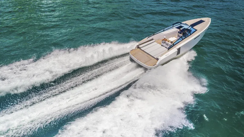 Slide: The Image of 2024 Evo Yachts R4 cruising on open water, leaving a wake behind. - 10