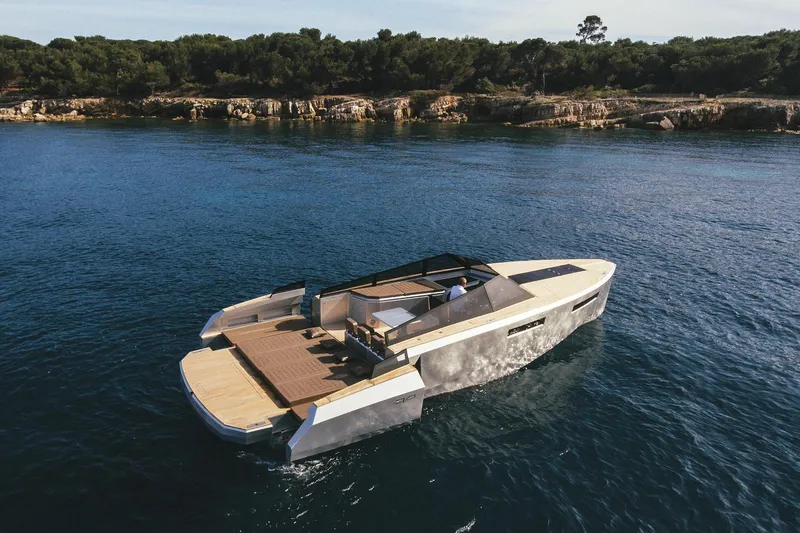 Slide: The Image of 2024 Evo Yachts R4 luxury yacht cruising near a rocky coastline. - 14