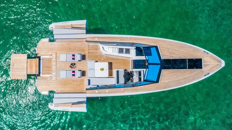 Slide: The Image of Aerial view of 2024 Evo Yachts R4 model on clear green water. - 18