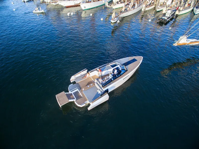 Slide: The Image of Aerial view of 2024 Evo Yachts R4 luxury yacht cruising near a marina. - 20