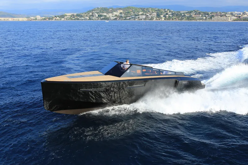Slide: The Image of 2024 Evo Yachts R4 cruising on the ocean near a coastal city. - 24