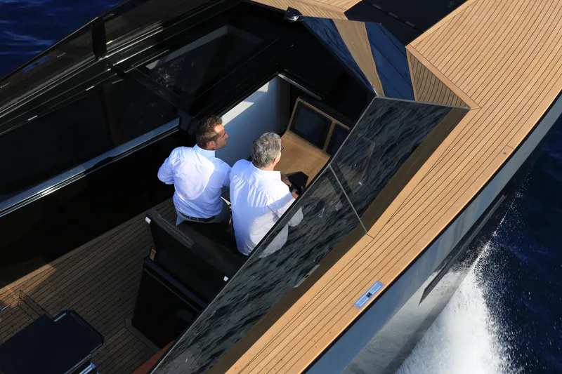 Slide: The Image of 2024 Evo Yachts R4 luxury yacht with two people on deck. - 25