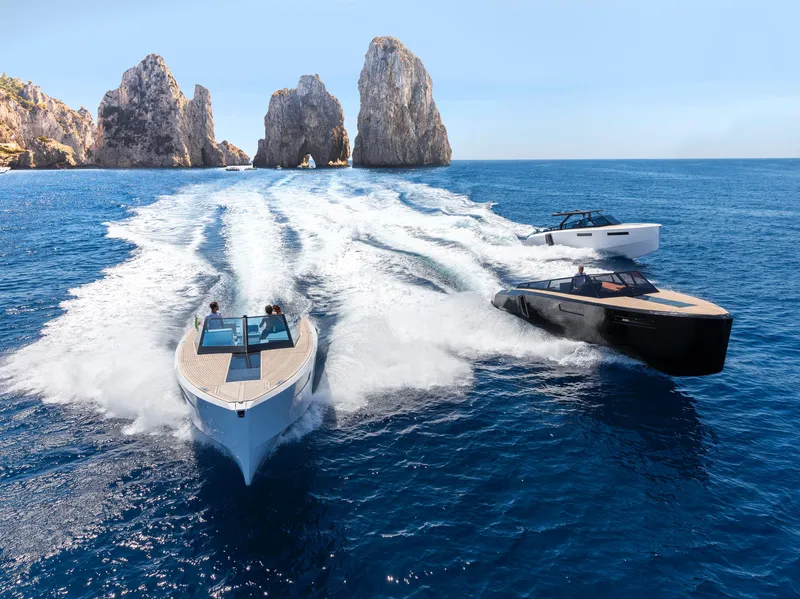 Slide: The Image of Evo Yachts R4 2024 models cruising near rocky cliffs in clear blue waters. - 7