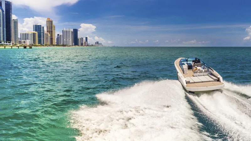 Slide: The Image of Evo Yachts R4 2024 cruising near a city skyline on a sunny day. - 8