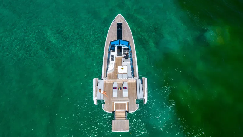 Slide: The Image of Aerial view of 2024 Evo Yachts R4 model on clear green water. - 9