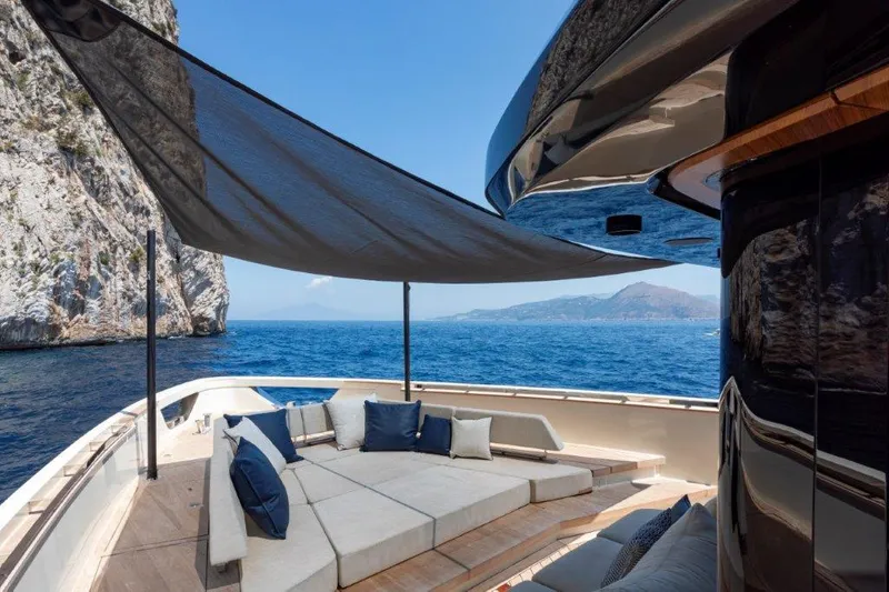Slide: The Image of Luxury Evo Yachts V8 2025 model, spacious deck with sunshade, scenic ocean view. - 11