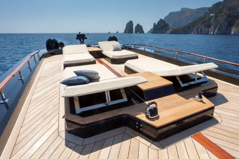 Slide: The Image of 2025 Evo Yachts V8 luxury yacht deck with sun loungers and scenic ocean view. - 13