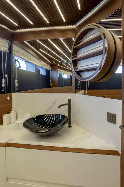 Slide: The Image of Modern bathroom on 2025 Evo Yachts V8 with sleek black sink and stylish lighting. - 18