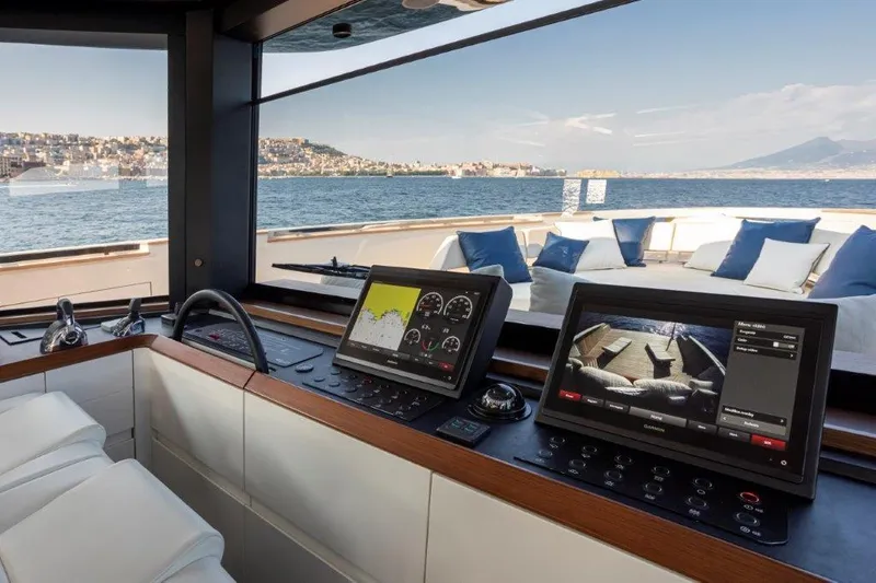 Slide: The Image of Cockpit view of 2025 Evo Yachts V8 with navigation screens and ocean backdrop. - 19