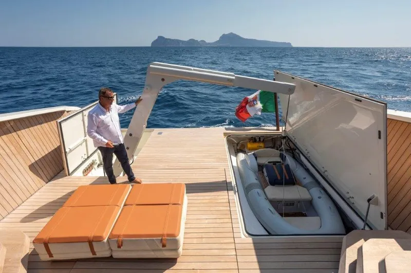 Slide: The Image of Evo Yachts V8 2025 model with a man on deck and a hidden inflatable boat. - 20