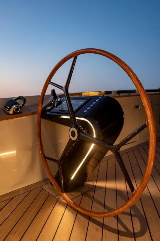 Slide: The Image of 2025 Evo Yachts V8 steering wheel and control panel at sunset. - 25