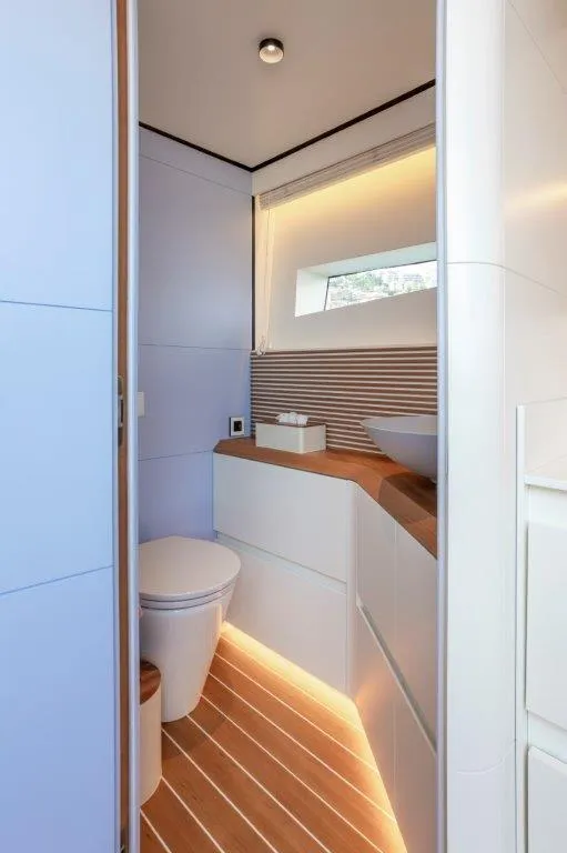 Slide: The Image of Modern bathroom interior on the 2025 Evo Yachts V8, featuring sleek design and ambient lighting. - 26