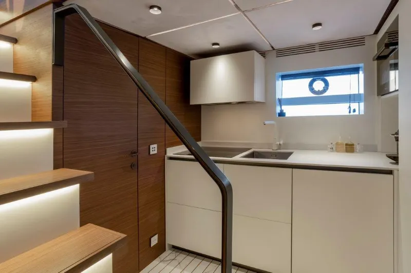 Slide: The Image of Modern kitchen interior of 2025 Evo Yachts V8 with wooden accents and sleek design. - 27