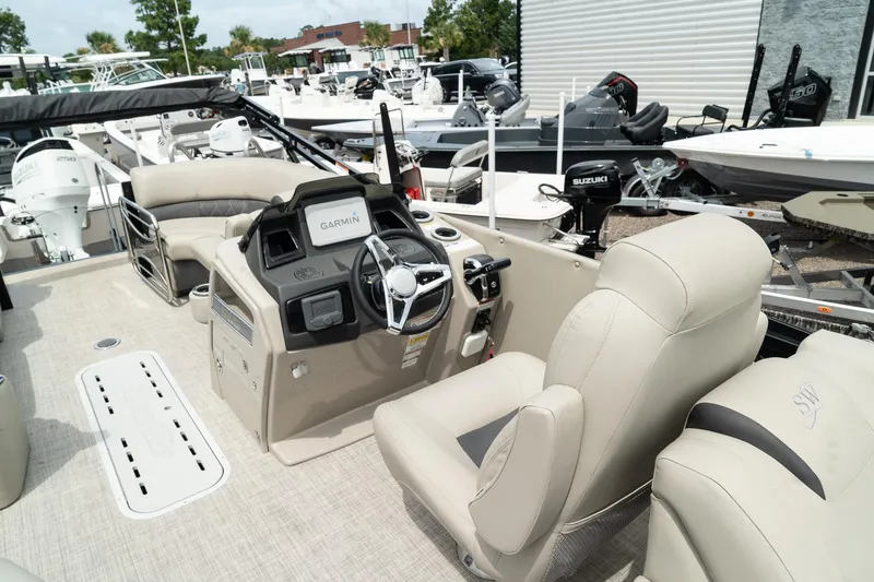 Slide: The Image of 2023 Silver Wave 2410 SW3 CLS boat interior with beige seating and modern dashboard. - 9