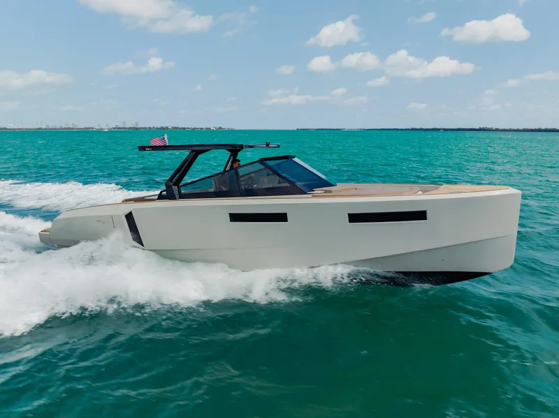 Slide: The Image of 2024 Evo Yachts R4 WA cruising on turquoise waters under a clear sky. - 21