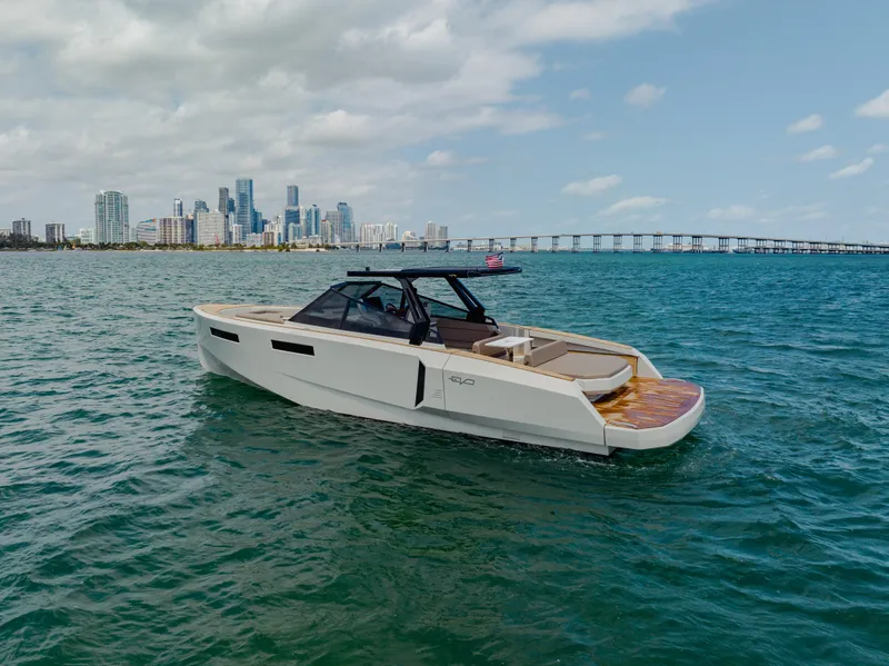 Slide: The Image of 2024 Evo Yachts R4 WA luxury yacht cruising near a city skyline. - 26