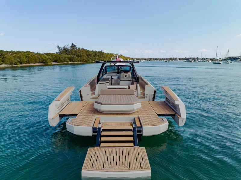Slide: The Image of 2024 Evo Yachts R4 WA luxury yacht with extended deck on serene water. - 30