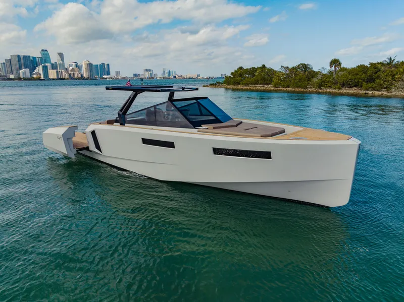 Slide: The Image of 2024 Evo Yachts R4 WA luxury yacht cruising near city skyline. - 33