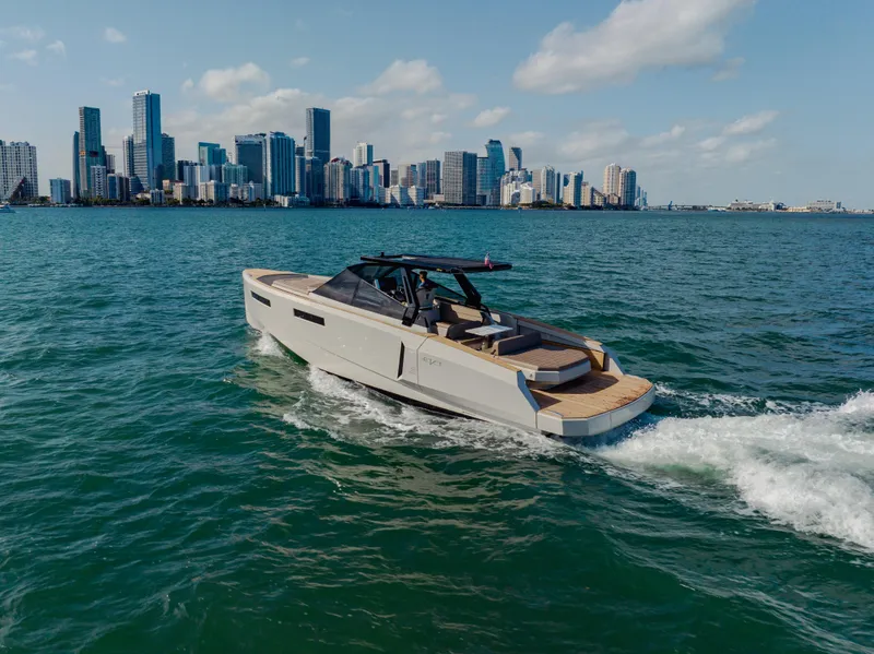 Slide: The Image of 2024 Evo Yachts R4 WA cruising near a city skyline. - 36