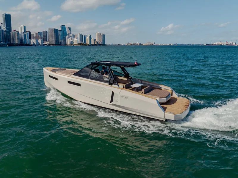 Slide: The Image of 2024 Evo Yachts R4 WA cruising near a city skyline. - 38