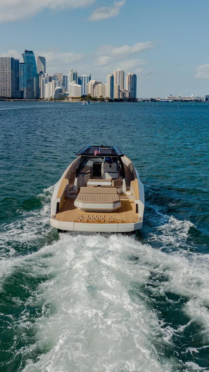 Slide: The Image of 2024 Evo Yachts R4 WA cruising near a city skyline. - 39
