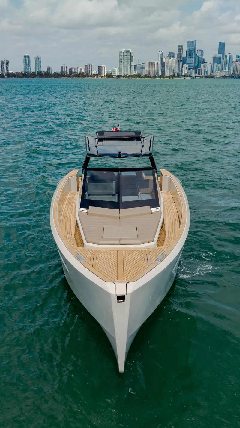 Slide: The Image of 2024 Evo Yachts R4 WA luxury yacht cruising near a city skyline. - 4