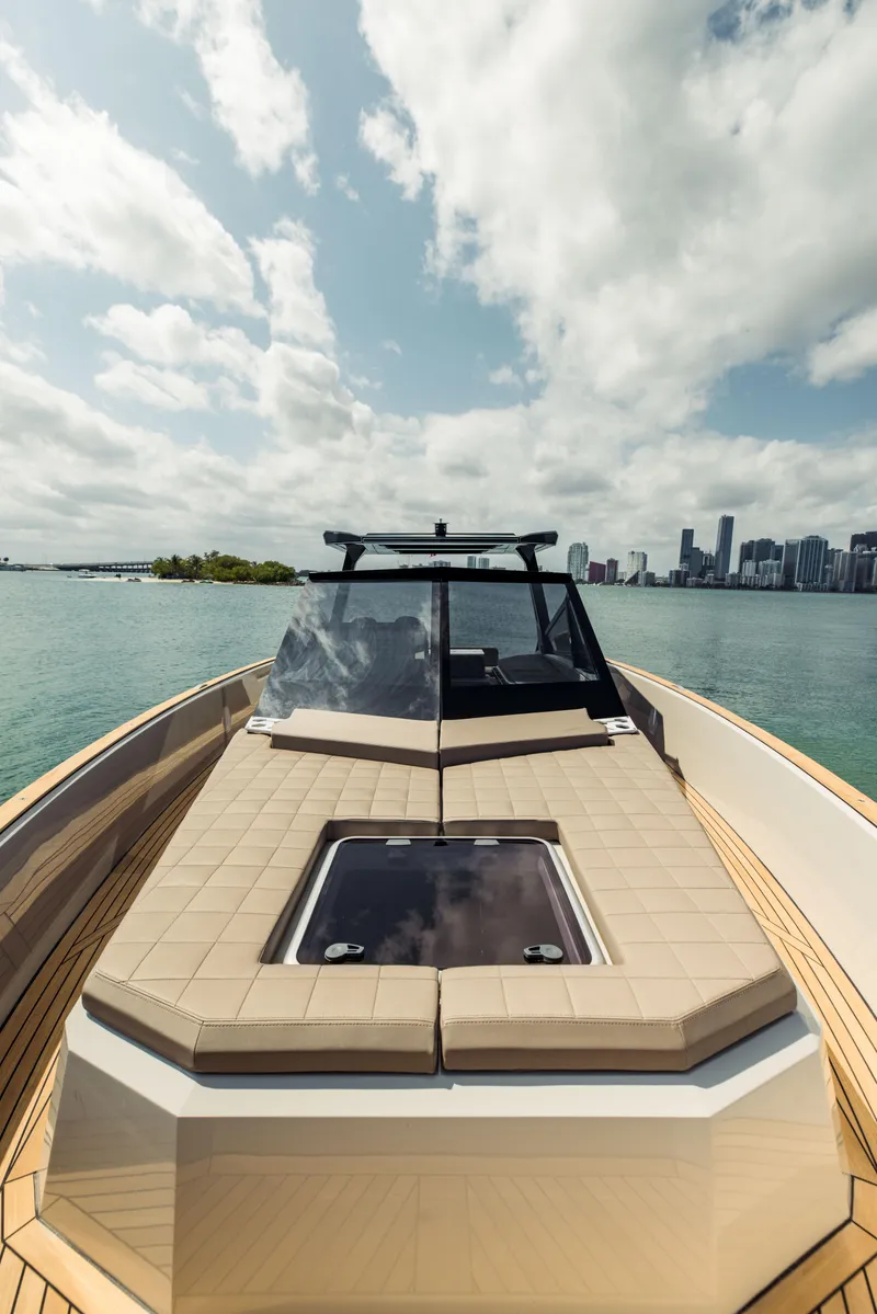 Slide: The Image of 2024 Evo Yachts R4 WA luxury yacht on calm waters with city skyline. - 42