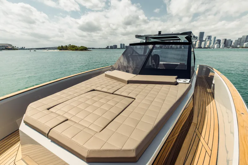 Slide: The Image of 2024 Evo Yachts R4 WA luxury yacht with spacious sun deck and city skyline in the background. - 43