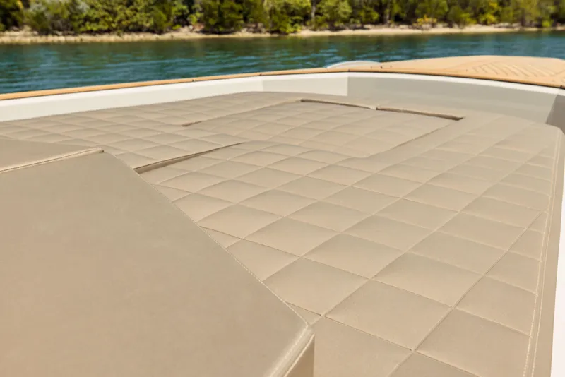 Slide: The Image of 2024 Evo Yachts R4 WA sun deck with quilted beige upholstery. - 45