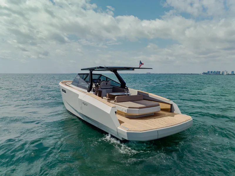 Slide: The Image of 2024 Evo Yachts R4 WA cruising on open water under a partly cloudy sky. - 6