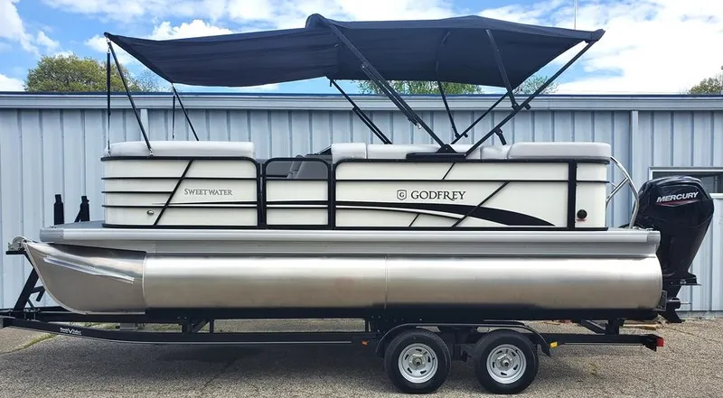 Slide: The Image of 2023 Sweetwater 2086 C pontoon boat on trailer with canopy. - 10