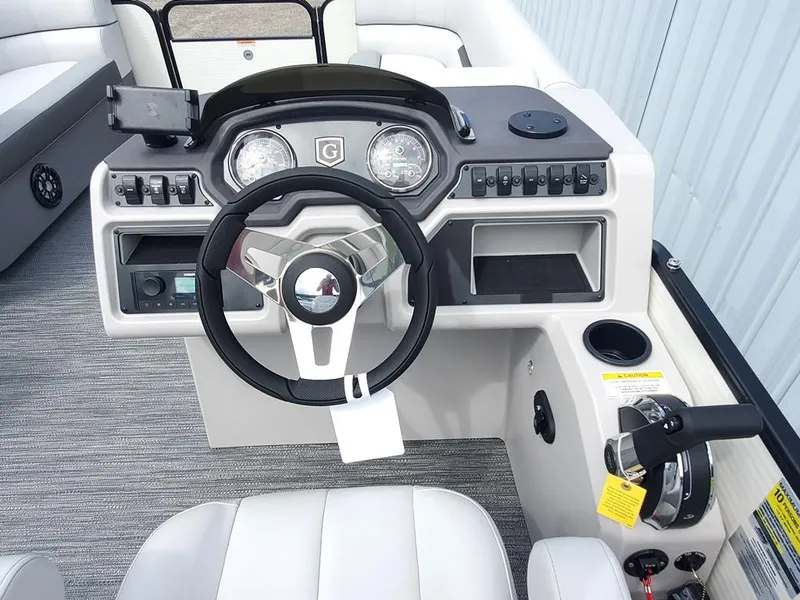 Slide: The Image of Sweetwater 2086 C 2023 boat dashboard with steering wheel and control panel. - 12