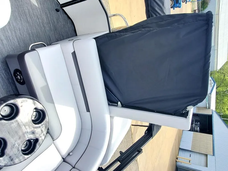 Slide: The Image of 2023 Sweetwater 2086 C pontoon boat interior with seating and table. - 6