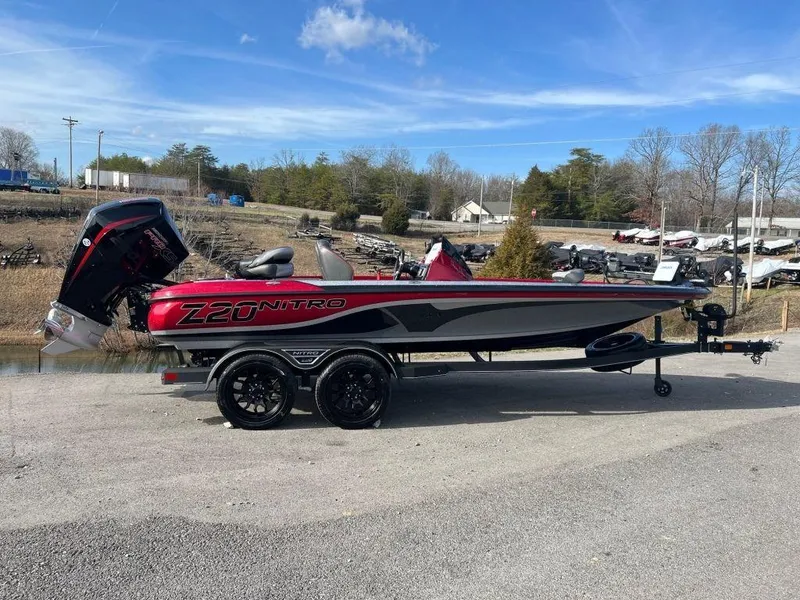 The Image of 2023 Nitro Z20 Pro boat on trailer, red and black, side view. - 1