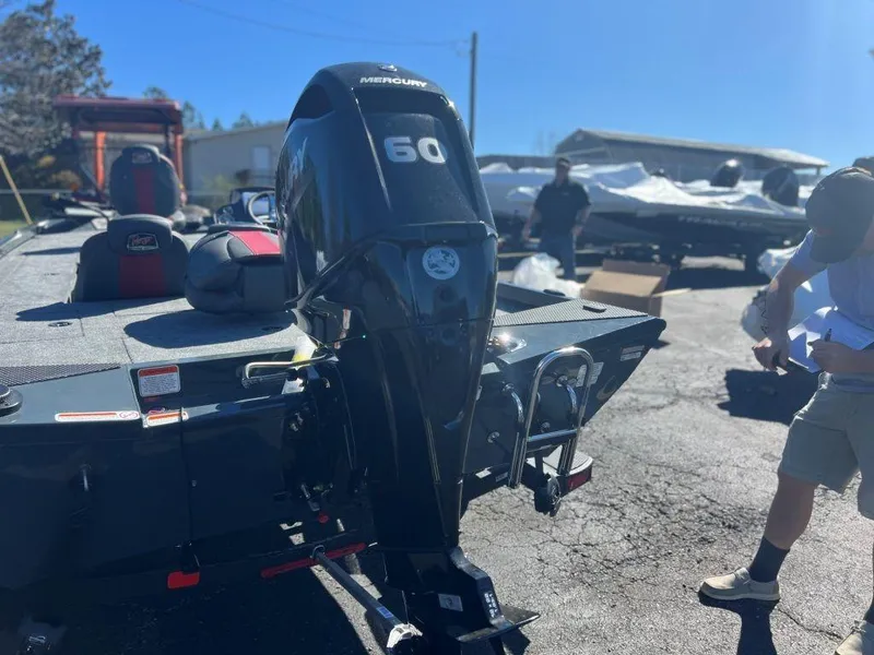 Slide: The Image of 2023 Ranger RT178C boat with Mercury 60 outboard motor in a parking lot. - 4