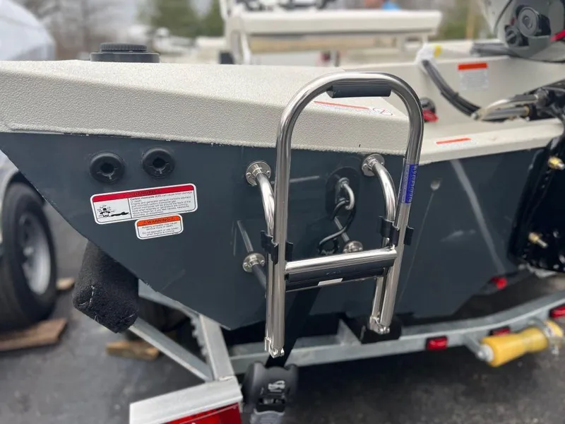 Slide: The Image of 2023 Ranger RB190 boat stern with ladder and safety labels. - 13