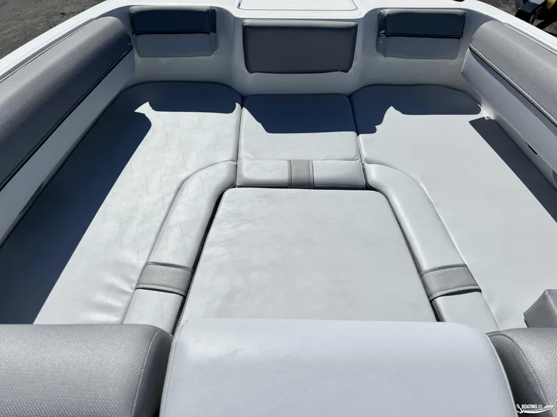 Slide: The Image of 2023 Bayliner DX2050 boat interior with spacious seating and cushioned layout. - 2