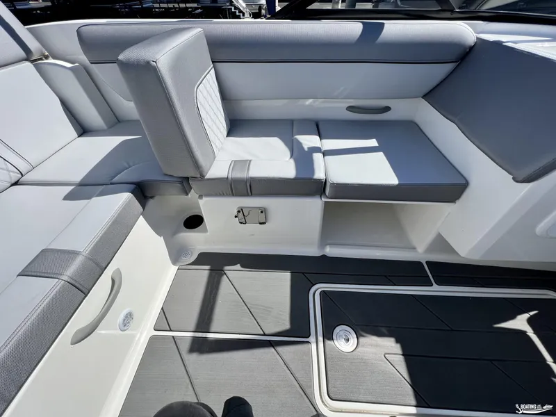 Slide: The Image of 2023 Bayliner DX2050 boat interior with gray seating and storage compartments. - 5