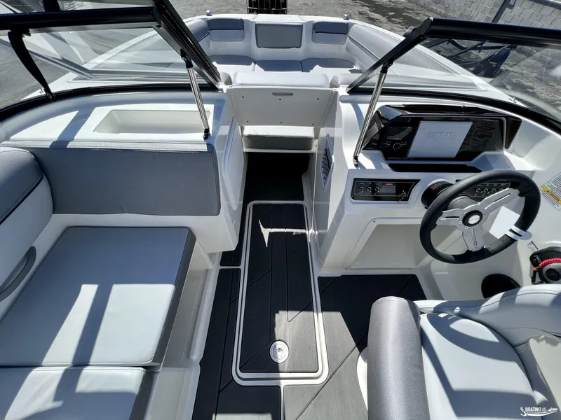 Slide: The Image of 2023 Bayliner DX2050 boat interior with modern dashboard and seating. - 8