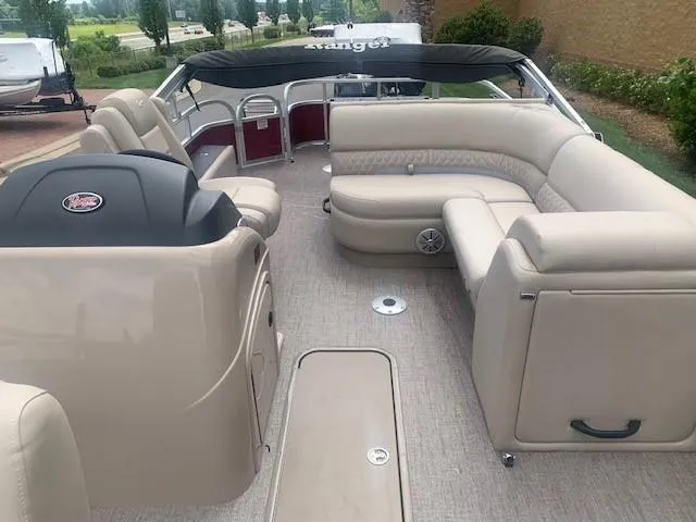 Slide: The Image of 2023 Ranger 223F pontoon boat with beige interior and spacious seating. - 4