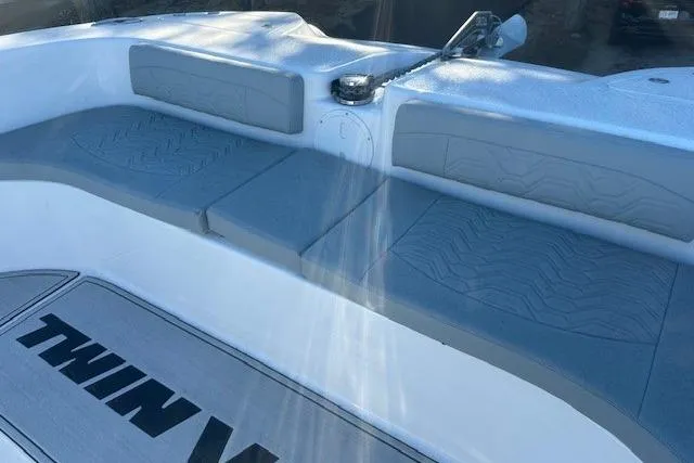 Slide: The Image of 2023 Twin Vee 340 GFX CC boat interior with cushioned seating and sleek design. - 3