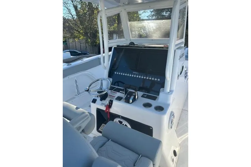 Slide: The Image of 2023 Twin Vee 340 GFX CC boat console with steering wheel and controls. - 4