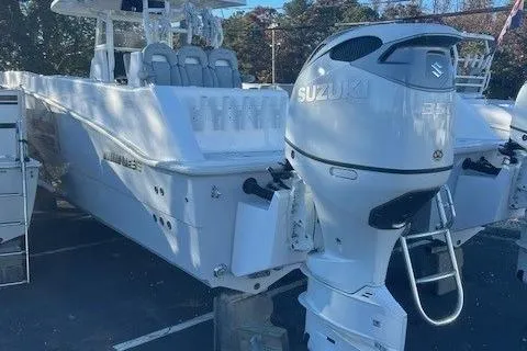 Slide: The Image of 2023 Twin Vee 340 GFX CC boat with Suzuki outboard engines, docked in a marina. - 5