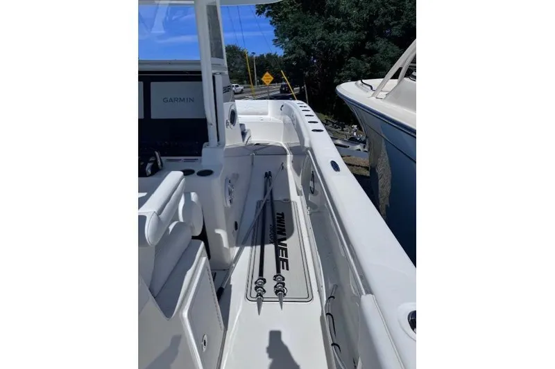 Slide: The Image of 2023 Twin Vee 280 GFX CC boat interior with fishing rods and Garmin equipment. - 10