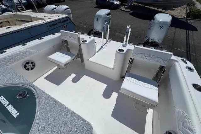 Slide: The Image of 2023 Twin Vee 280 GFX CC boat interior with seating and dual outboard engines. - 12