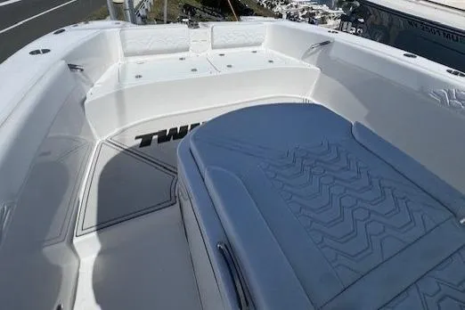 Slide: The Image of 2023 Twin Vee 280 GFX CC boat interior with cushioned seating and sleek design. - 16