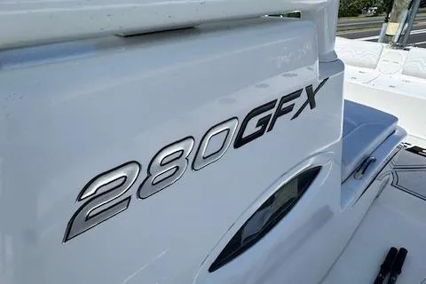 Slide: The Image of 2023 Twin Vee 280 GFX CC boat, sleek design, close-up view of model name. - 20