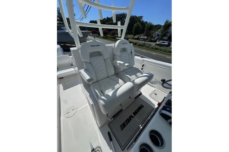 Slide: The Image of 2023 Twin Vee 280 GFX CC boat with white cushioned seats and console. - 21